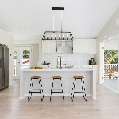 monochrome ultimate coast Hamptons kitchen with stone island bench and wrap around verandah